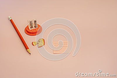 A sharpened orange pencil with a small eraser on one end next Stock Photo