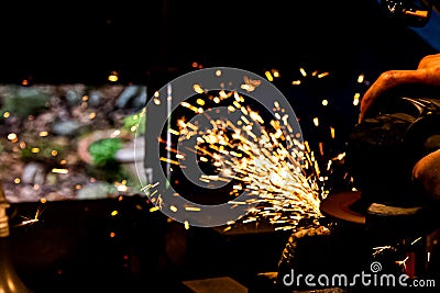 Sharpening Japanese sword with grinder Stock Photo