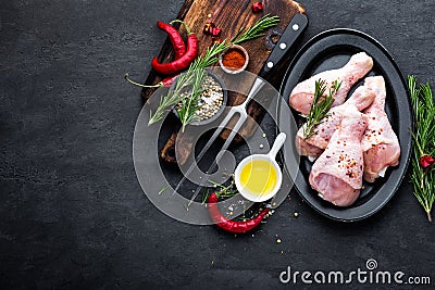 Shashlik marinated for grill in onion, chili peppers and spices. Raw pork meat for spicy shish kebab on skewers on black backgroun Stock Photo