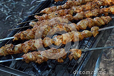 Shashlik - traditional Georgian barbecue. Closeup of raw roasted marinated meat barbecue shish kebab shashlik on steel metal Stock Photo