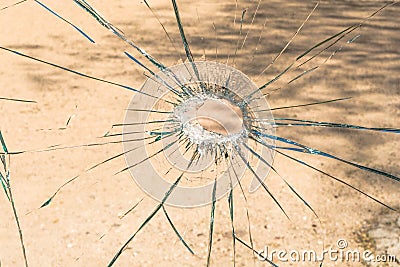 A shattered glass with a hole in the middle. Stock Photo