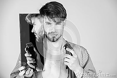 Shaves or does not shave. Man with half shaven face chin and beard Stock Photo