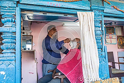Shaving a beard right on the street 13 April 2018 Kathmandu, Nep Editorial Stock Photo