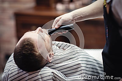 Shaving beard trimmer at the hairdresser Stock Photo