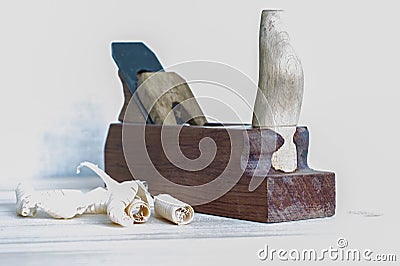 Shavings after planing of wood ash on the background of the plane close up. DIY concept. Woodworking and crafts tools Stock Photo