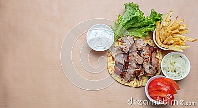 Shawarma, gyros on pita bread, vegetables and tzatziki sauce, top view. Traditional turkish, greek meat food Stock Photo