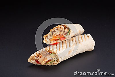 Shawarma sandwich - fresh roll of thin lavash or pita bread filled with grilled meat, mushrooms, cheese, cabbage, carrots, sauce, Stock Photo