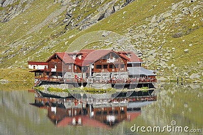 A chalet on the lake up in the mountains Stock Photo