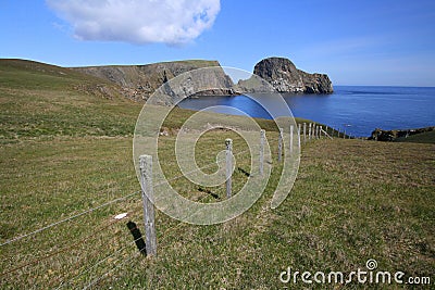 Fence and Sheep Rock Stock Photo