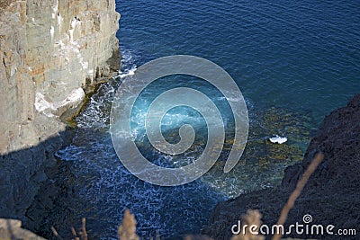 Sheer rock, going into the sea, where the birds nest. Stock Photo