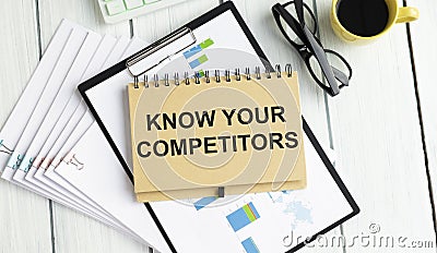 Inscription KNOW YOUR COMPETITOR, next to a pencil pointing to it, and glasses Stock Photo