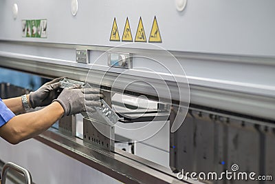 The sheet metal bending machine operation and control by expert operator. Stock Photo