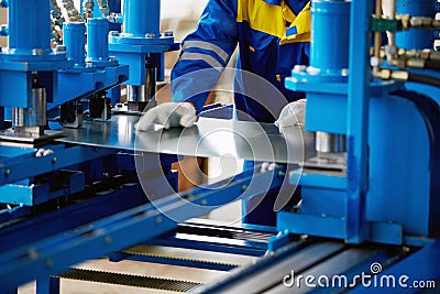 Sheet of metal and hands of worker Stock Photo