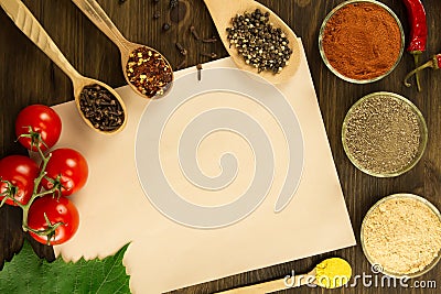 Sheet old vintage paper with spices on wooden background. Healthy vegetarian food. Recipe, menu Stock Photo