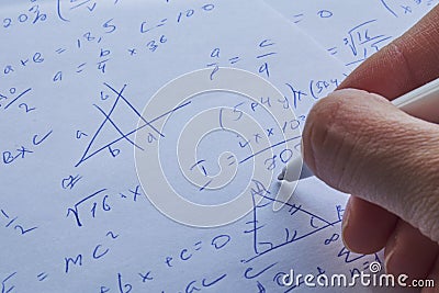 Sheet of paper filled with calculations as a background. Math problems on graph with pencil. Doing algebra some school Stock Photo