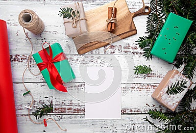 a sheet of paper lies on a white table next to gifts Stock Photo