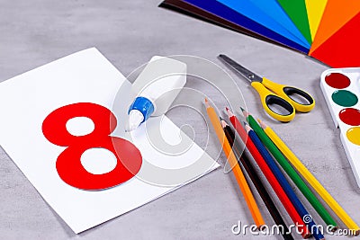 Sheets of paper, glue and scissors on a table. March 8 from paper Stock Photo