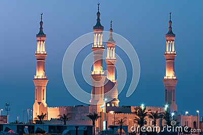 Sheikh`s Zayed`s Mosque glowing colors in Ras al Khaimah, UAE at night echos prayer call along the Corniche Stock Photo