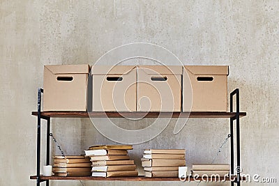 Shelf with boxes and books Stock Photo