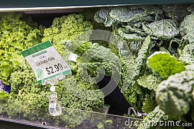 a shelf filled with organic lacinato kale for $2.99 each at the vegan market in Atlanta Georgia Editorial Stock Photo