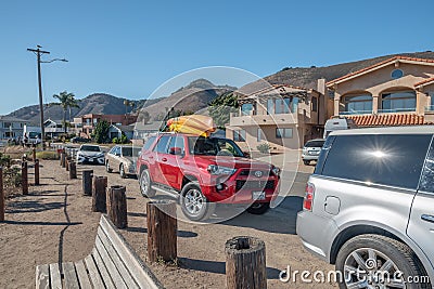 Beach street view, cars with kayaks mounted on top. Shell Beach is a best spot along the coast for diving and kayaking Editorial Stock Photo