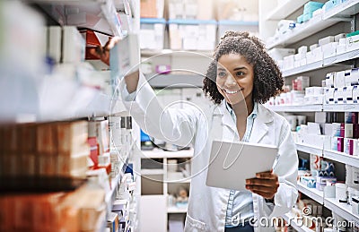 Shell get you exactly what you need. an attractive young female pharmacist working in a pharmacy. Stock Photo