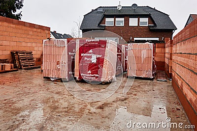 Shell of the ground floor of a family house with the warehouse of aerated concrete blocks for the construction of the walls Editorial Stock Photo