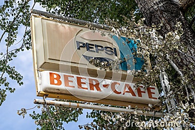 Old rustic and vintage Pepsi brand soda sign at a cafe and bar in the small town Editorial Stock Photo