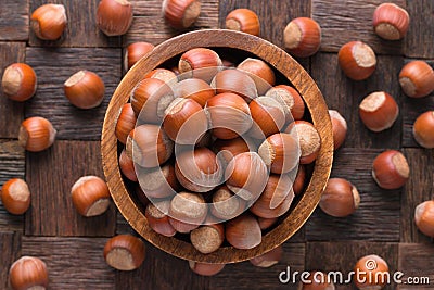 Shelled forest nuts in wooden bowl, top view Stock Photo