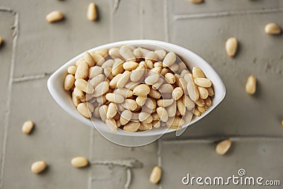 Shelled pine nuts in a white bowl Stock Photo