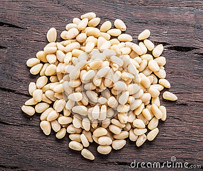 Shelled pine nuts on the wooden table. Top view. Organic food Stock Photo