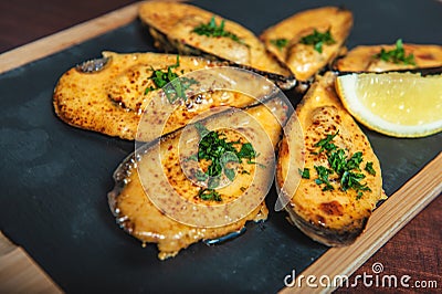 Shellfish mussels with herbs and lemon on the cutting board Stock Photo