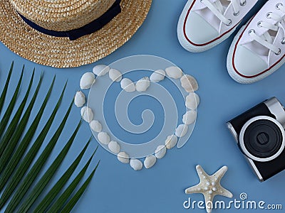 Shells, a sea ster, sneakers, a tropical leaf, a summer hat and camera Stock Photo