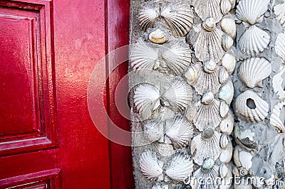 shells wall and red door Stock Photo