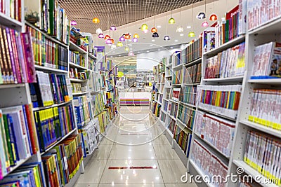 Shelves with books in a bookstore. Large selection of diverse literature. On the floor there is a marking for buyers to observe Editorial Stock Photo