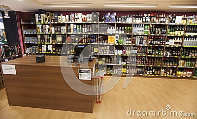 Shelves with bottles. Shelving, shop and cash Editorial Stock Photo