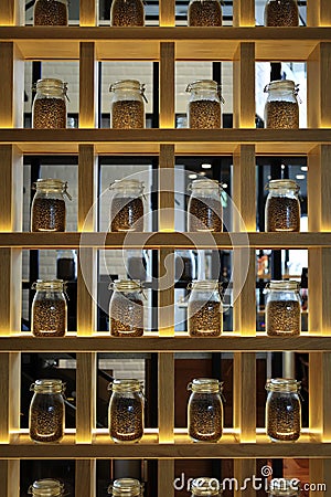 SHELVES FILLED WITH COFFEE BEANS POTS Stock Photo