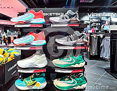 Shelves of Nike sneakers and sport wears with discounts on sale in the shopping mall Editorial Stock Photo