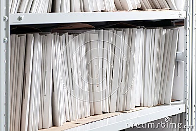 shelves with paper documents. Organized office space with neatly arranged paper documents and file cabinets Stock Photo