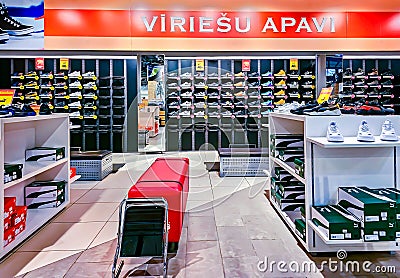 Shelves of sneakers from famous sports manufacturers with discounts on sale in the shopping mall Editorial Stock Photo