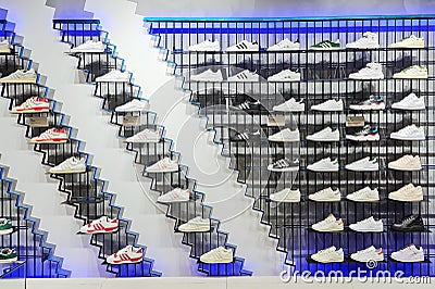 Shelves of sneakers for various workouts on promotion price discount in the shopping mall in Riga Editorial Stock Photo