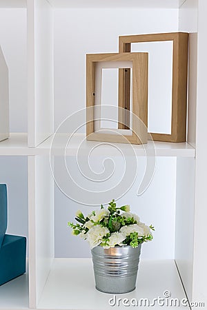 Shelving unit flower and frames Stock Photo