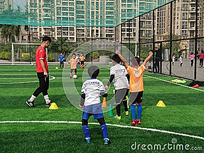 Shenzhen, China: children train to play soccer during winter vacation Editorial Stock Photo