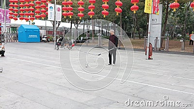 Shenzhen, China: elderly people play top as a fitness exercise in the morning sports square Editorial Stock Photo