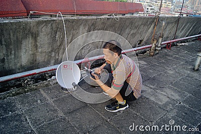 Shenzhen, China: the installation of satellite TV receiver Editorial Stock Photo