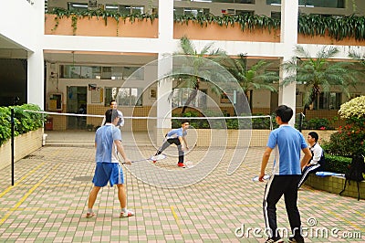 Shenzhen, China: middle school students playing badminton Editorial Stock Photo
