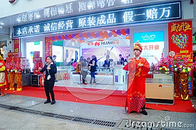 Shenzhen, China: mobile phone stores opened, Sun Wukong and young women dancing to attract customers Editorial Stock Photo