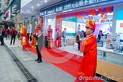 Shenzhen, China: mobile phone stores opened, Sun Wukong and young women dancing to attract customers Editorial Stock Photo