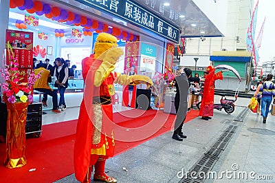 Shenzhen, China: mobile phone stores opened, Sun Wukong and young women dancing to attract customers Editorial Stock Photo