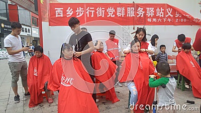 Shenzhen, China: party and group service stations offer free haircuts for citizens Editorial Stock Photo